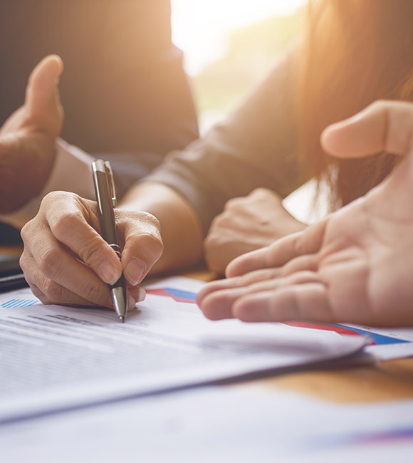 close-up of hands signing a document