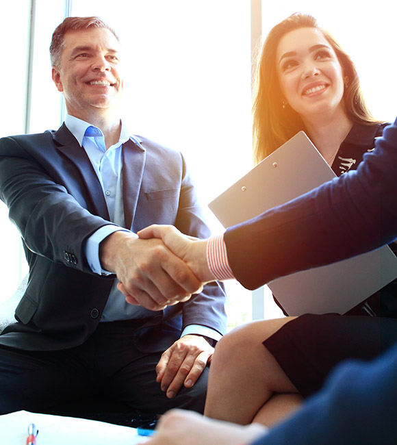 lawyer shakes hands with others in suits
